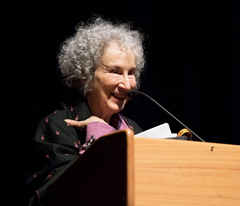 Margaret Atwood standing behind a microphone