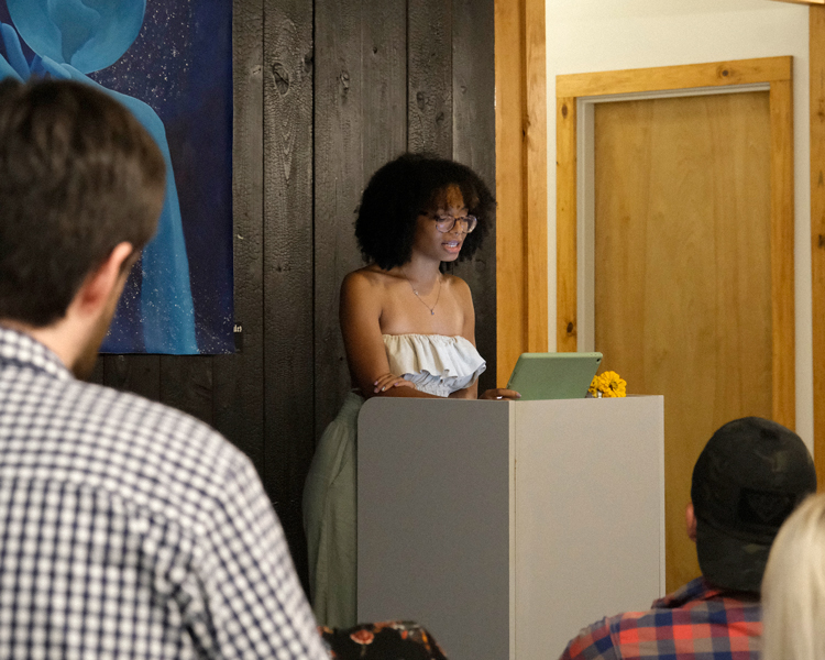 graduate student reading at an MFA event